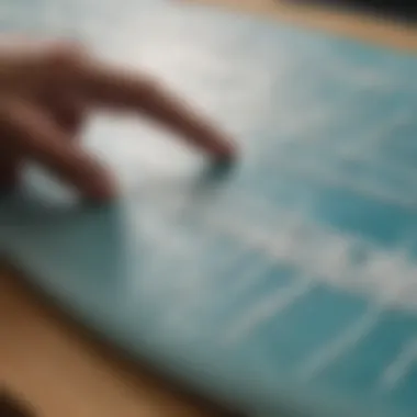 Close-up view of a surf patch being applied to a surf board with an iron