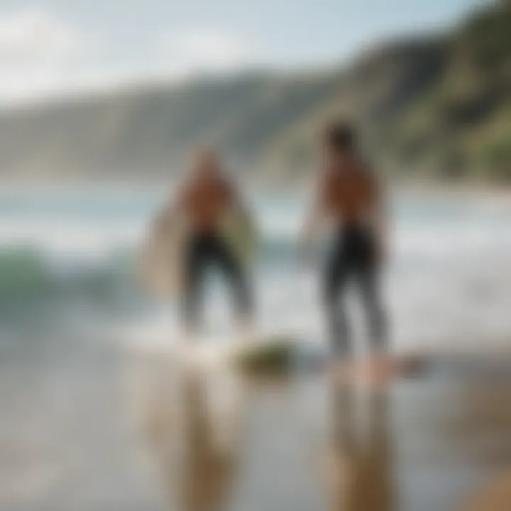 An experienced surfer giving a lesson to a beginner on the beach