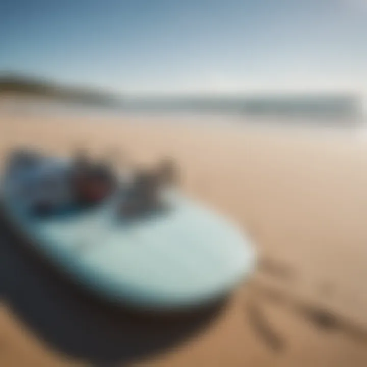 Close-up of a kite surfing board and gear resting on the beach