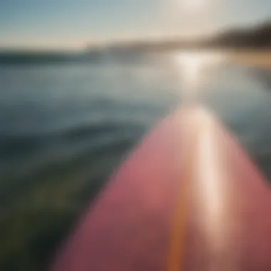 Side profile of a resin tint surfboard reflecting sunlight on the ocean.