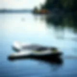 A foldable paddleboard displayed in an unfolded state on a serene lake