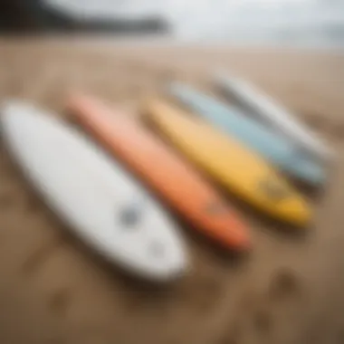 Close-up of surfboards lined up on the sand