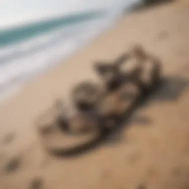 A pair of stylish surf sandals resting on a sandy beach