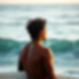 A surfer observing ocean swells in a thoughtful manner.
