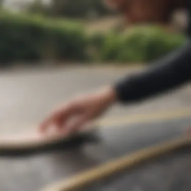 Skateboard deck being applied with tape