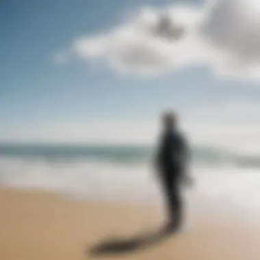 A surfer checking wind conditions with a handheld anemometer on the beach.